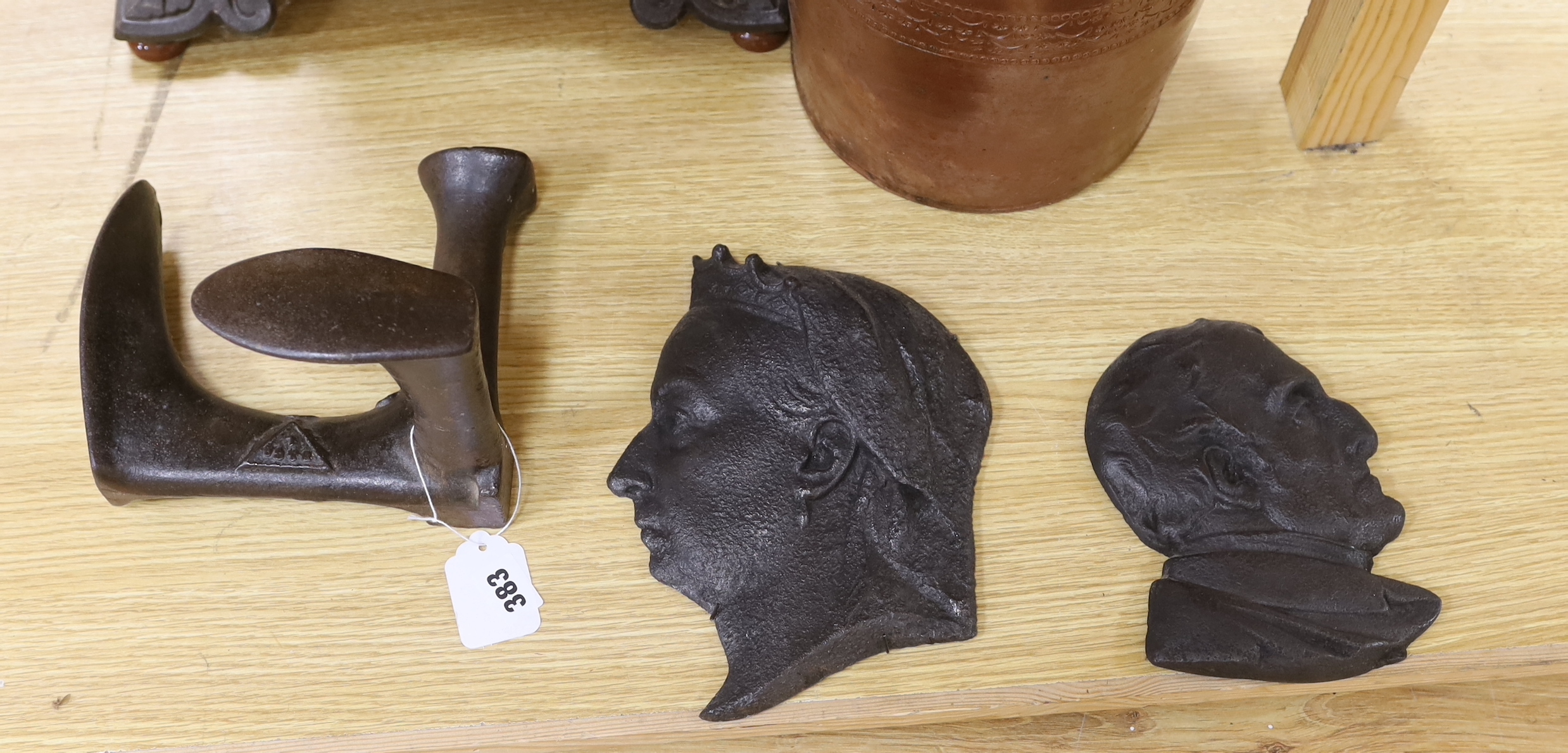 Metalware comprising wrought iron heater, two metal plaques including one of Queen Victoria, boot makers anvil, and a stoneware vase, the largest 53cm high